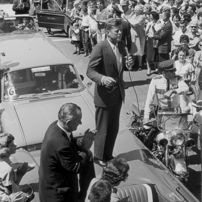 JFK on Hood of Car by Andy Hanson